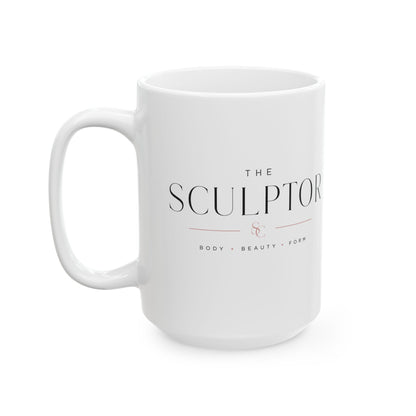 A white ceramic mug with a handle, featuring the text 'THE SCULPTOR' and 'BODY • BEAUTY • FORTH' printed in black and a small rose gold accent on the front, set against a plain white background. Apparel, accessories and mugs for body contouring specialists.