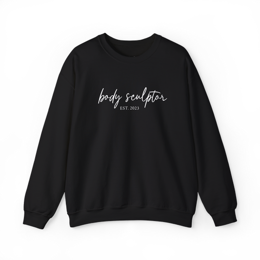 black crewneck sweatshirt with 'body sculptor EST. 2024' printed in white script across the chest, posed against a neutral gray background. Sweatshirt for body contouring specialists.