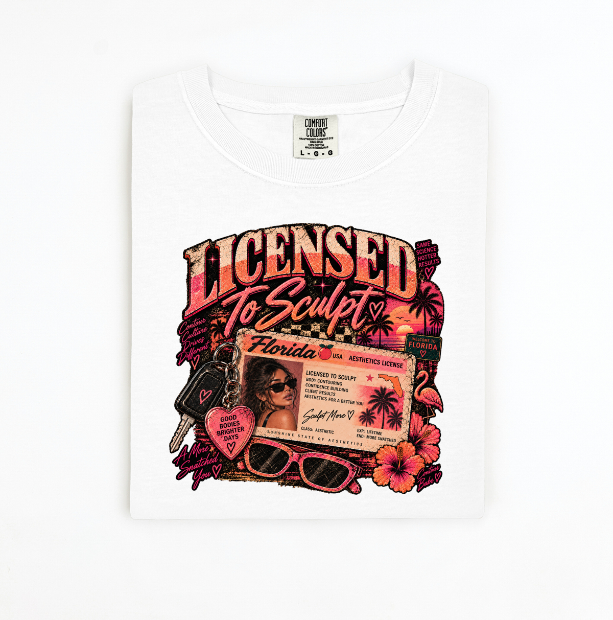 A white crewneck t-shirt with a colorful graphic print on the front. The graphic features the text 'LICENSED To Sculpt' in a distressed font, a Florida driver's license card, sunglasses, a heart-shaped sign reading 'I Love Florida', and palm trees. Clothing, apparel, and accessories for body contouring specialists and beauty professionals.