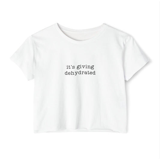 A white short-sleeve crop top t-shirt with the text 'it's giving dehydrated' printed in black typewriter font on the chest, displayed against a plain white background.